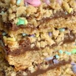Easter Goody Bars | Goody Bars | Easter Recipe | Easter Goody Bars are the perfect springtime treat! A pecan and oat crumble mixture for the crust, filled with a creamy fudge filling, topped with more crumble and Easter m&m candy and sprinkles. #easter #easterrecipes #dessert #dessertrecipes #recipeoftheday #holidayrecipes