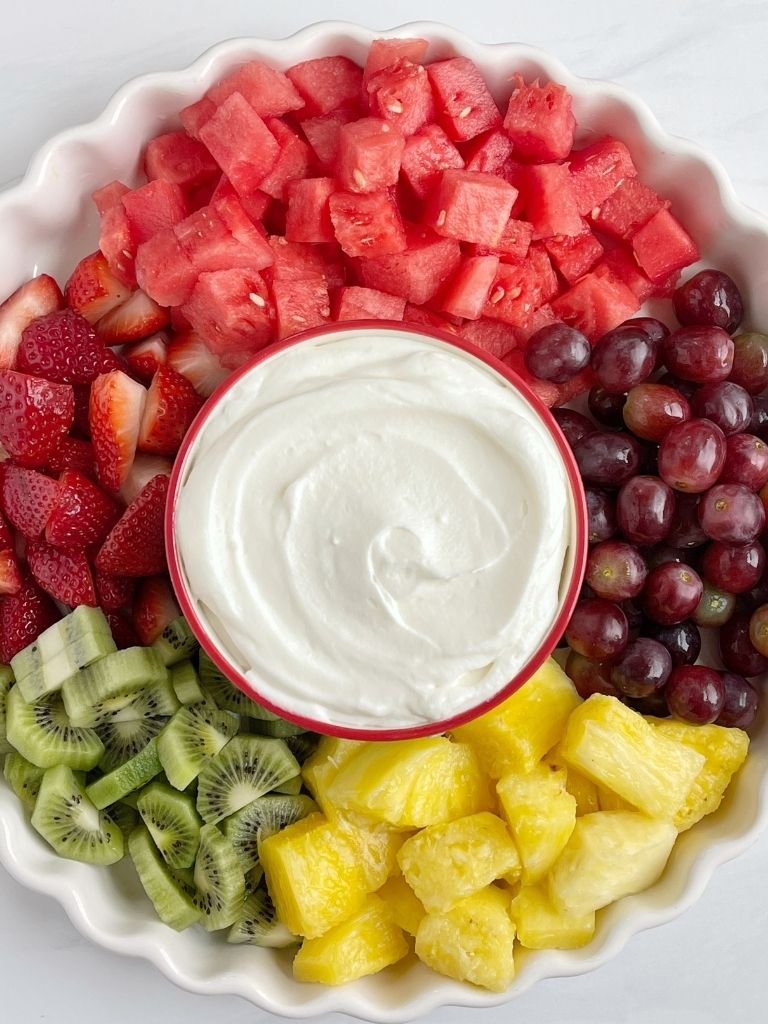 Fruit dip made with only 4 ingredients and served on a plate of fresh fruit.
