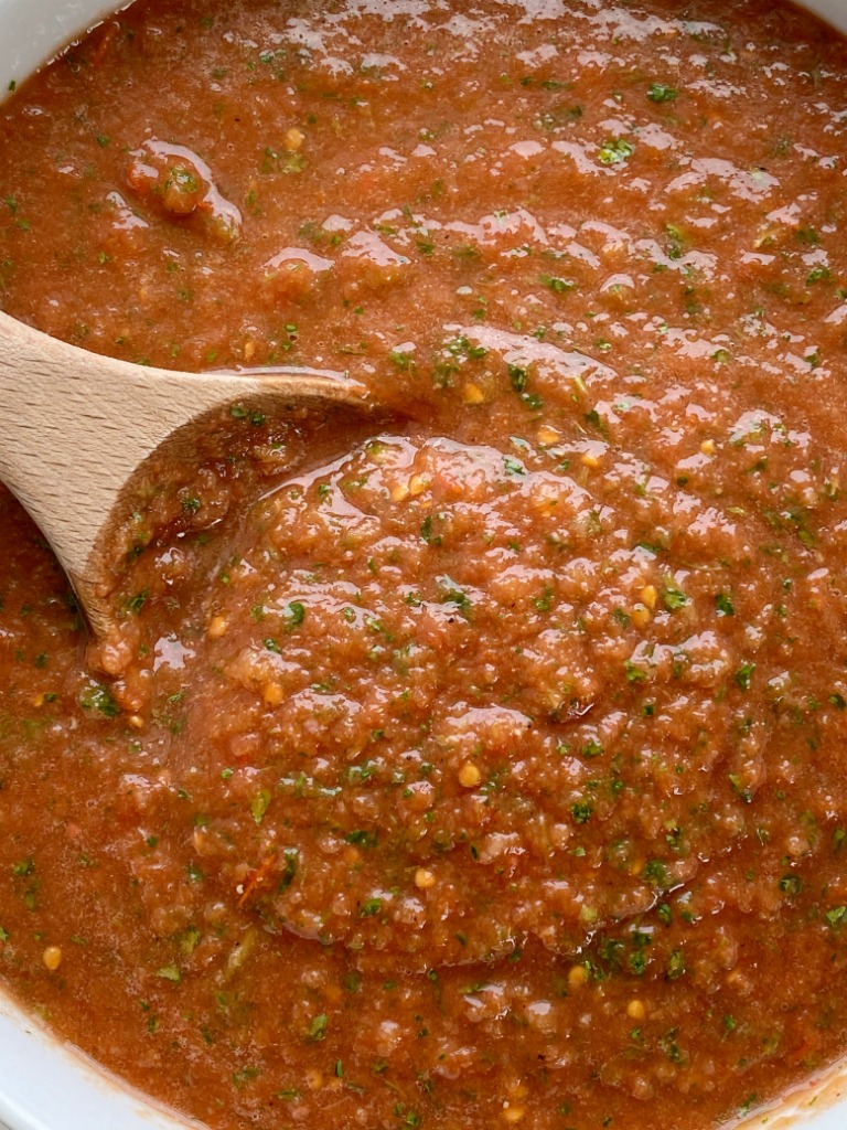 Homemade Salsa with canned whole tomatoes, stewed tomatoes, onion, garlic, jalapeno, cilantro, and seasonings. So simple to make, inexpensive, and it tastes better than anything you'll get at the restaurant or buy in the store. Mild enough for kids but can easily be made spicy!