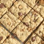 Oatmeal Chocolate Chip Peanut Butter Bars | Oatmeal chocolate chip peanut butter bars are a family favorite dessert that everyone loves. Soft cookie bars loaded with oatmeal, peanut butter, peanut butter chips, and chocolate chips. Everyone loves these soft-baked cookies bars. #easydessertrecipes #dessert #peanutbutter #chocolate