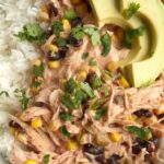 5 ingredients + some spices are all you need for slow cooker creamy fiesta chicken. Takes just minutes to prepare and it's ready when you are. Serve with cooked rice and toppings if your choice. Let everyone create their own creamy fiesta chicken rice bowl for dinner.