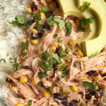 5 ingredients + some spices are all you need for slow cooker creamy fiesta chicken. Takes just minutes to prepare and it's ready when you are. Serve with cooked rice and toppings if your choice. Let everyone create their own creamy fiesta chicken rice bowl for dinner.