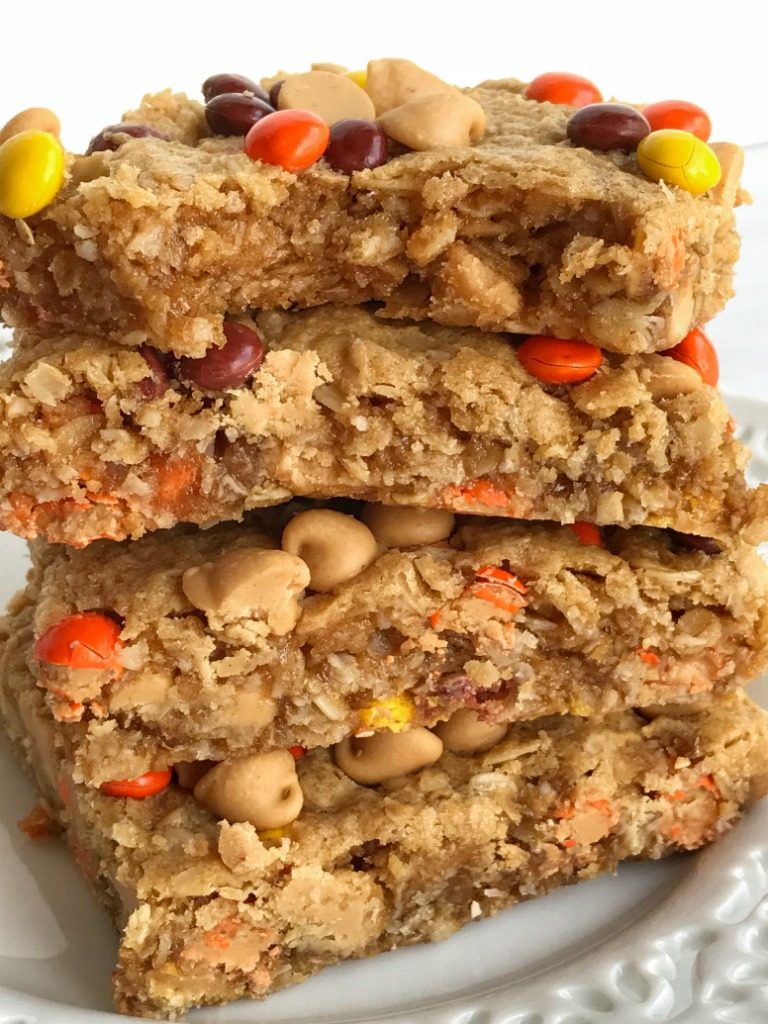 No flour triple peanut butter monster cookie bars are loaded with peanut butter, peanut butter chips, mini reese's pieces, and oatmeal! This recipe makes an entire cookie sheet of bars & they freeze perfectly. Perfect for lunchboxes or snacks for the week. 