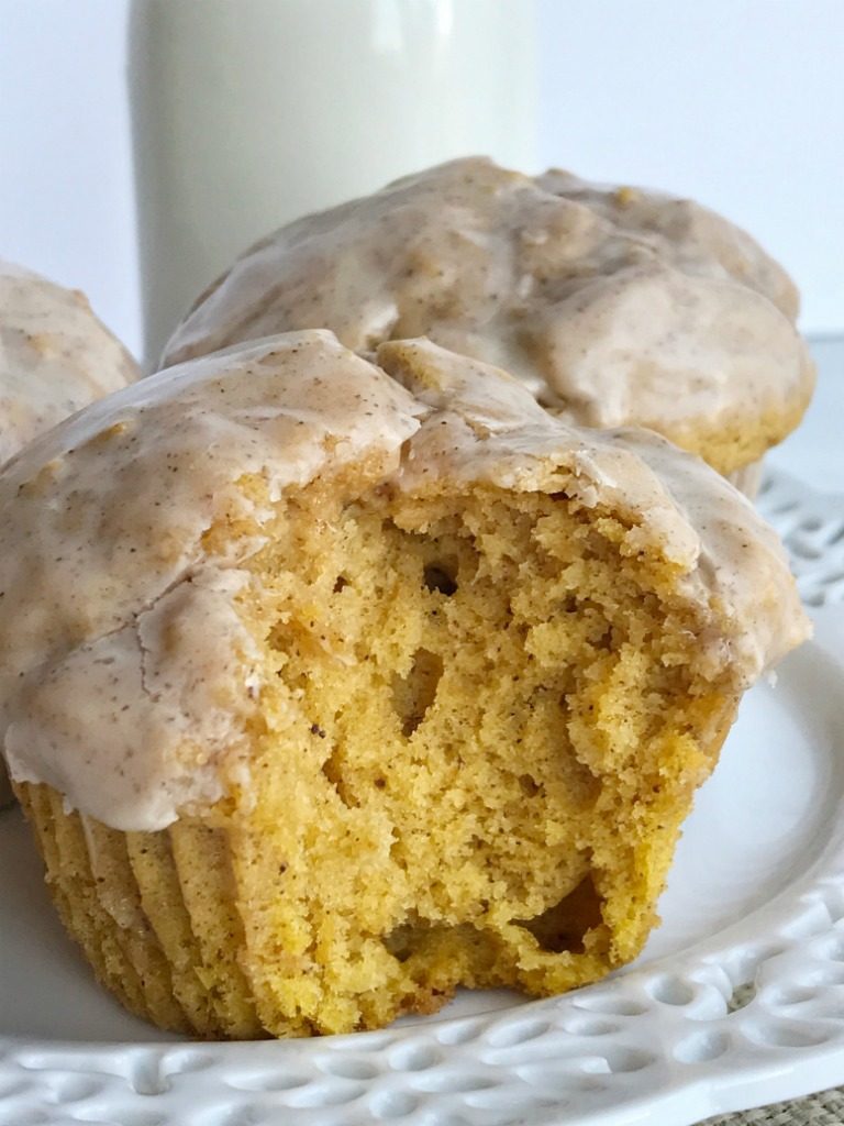 Pumpkin donut glazed muffins bake up perfectly and are so soft & fluffy. Full of pumpkin and pumpkin spices and then dipped in a delicious maple cinnamon glaze. 