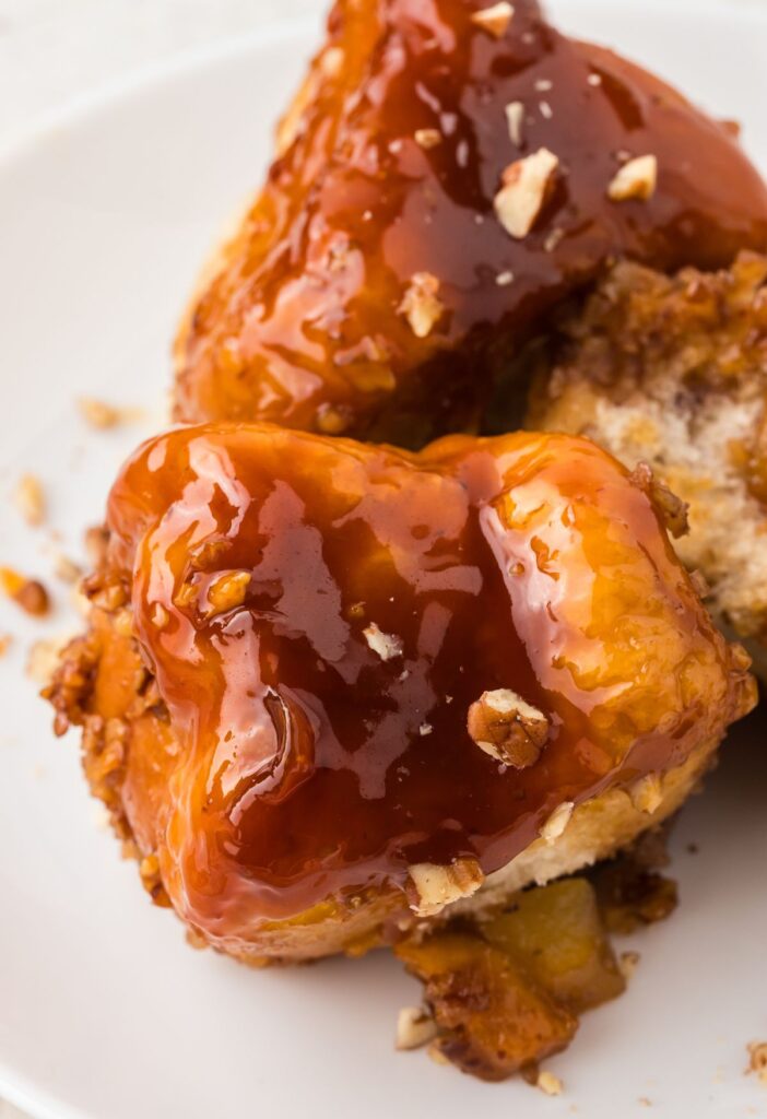 Serving pieces of the monkey bread on a white plate.