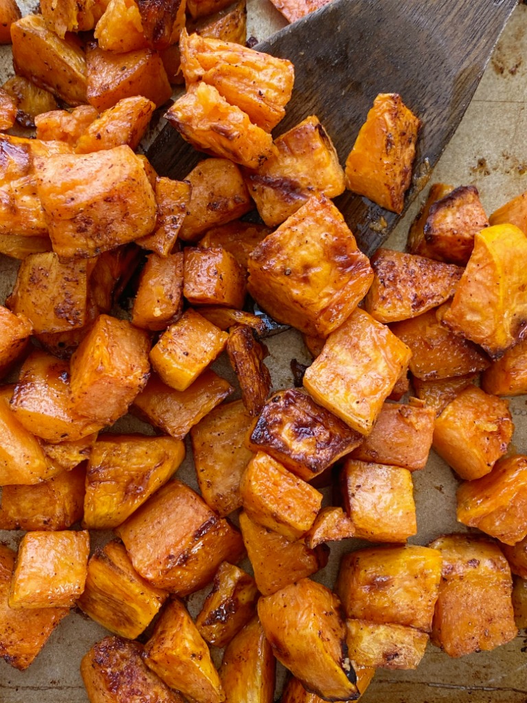 Maple Cinnamon Roasted Sweet Potatoes taste just like sweet potato casserole but healthier! Diced sweet potatoes are covered in a delicious marinade of olive oil, real maple syrup, spices, cinnamon and roasted to perfection in the oven.