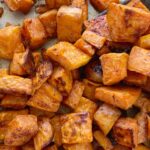 Maple Cinnamon Roasted Sweet Potatoes taste just like sweet potato casserole but healthier! Diced sweet potatoes are covered in a delicious marinade of olive oil, real maple syrup, spices, cinnamon and roasted to perfection in the oven.