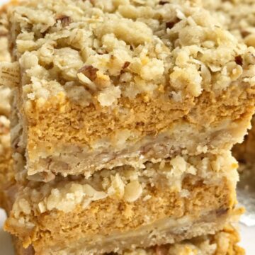Pumpkin pie crumble bars tastes just like pumpkin pie but in bar form! A brown sugar, oat, pecan crumble with a sweet and creamy pumpkin cheesecake middle. These bars are one of our favorite pumpkin desserts. They are a must-make. 