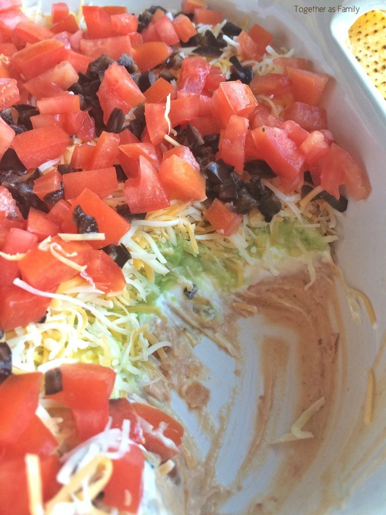 Layers of beans, sour cream, fresh guacamole, shredded cheese, and loaded with fresh veggies! This 7 layer dip will be one that no one can refuse. Serve with some crisp corn tortilla chips.