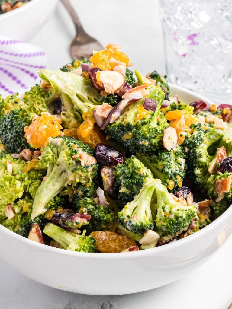 Bowl of broccoli salad with a fork in it. 