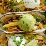 Delicous vegetable tacos are the perfect vegetarian recipe for Taco Tuesday! Cabbage, bell peppers, corn, black beans, onion, brown rice, and fresh lime.