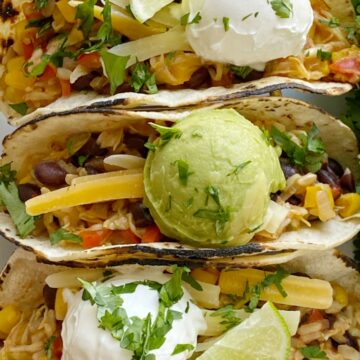 Delicous vegetable tacos are the perfect vegetarian recipe for Taco Tuesday! Cabbage, bell peppers, corn, black beans, onion, brown rice, and fresh lime.