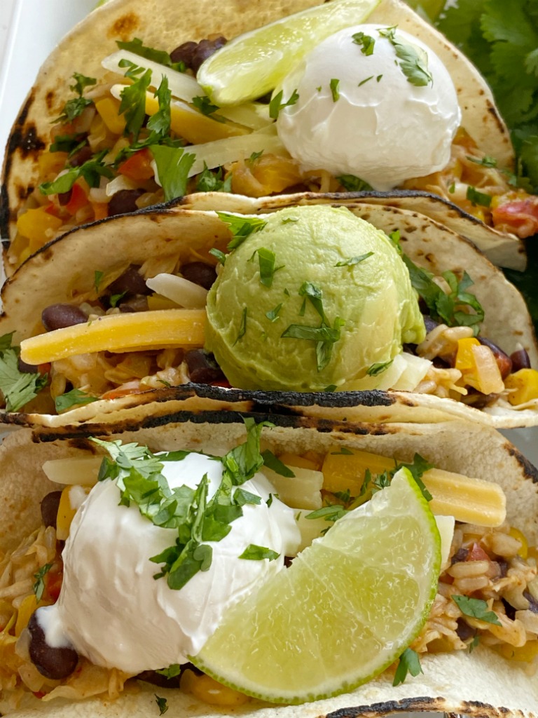 Delicous vegetable tacos are the perfect vegetarian recipe for Taco Tuesday! Cabbage, bell peppers, corn, black beans, onion, brown rice, and fresh lime.