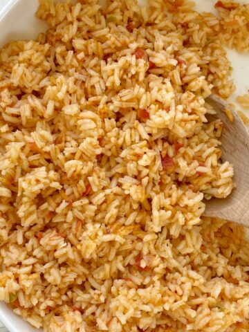 Easy Mexican Rice uses simple ingredients like canned chicken broth, prepared salsa, and there is no chopping needed! Fluffy, flavorful Mexican rice that is so easy to make in one pot.