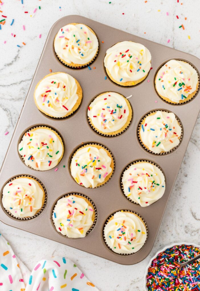 hero image of a pan of cupcakes with frosting and sprinkles