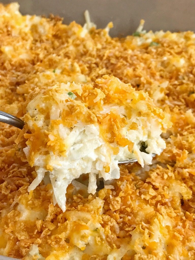 Frozen shredded potatoes make this cheesy shredded potato casserole side dish so easy to prepare! Loaded with cheese, green onions, and sour cream. Topped with a crunchy & cheesy topping that gets crispy while cooking