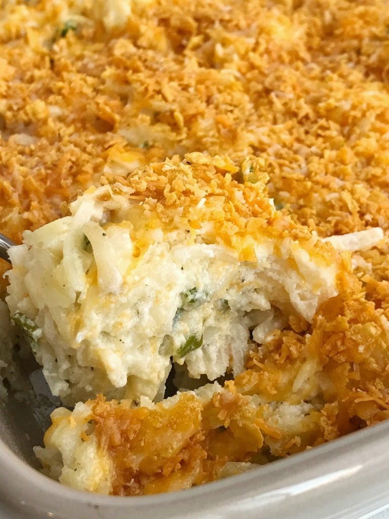 Frozen shredded potatoes make this cheesy shredded potato casserole side dish so easy to prepare! Loaded with cheese, green onions, and sour cream. Topped with a crunchy & cheesy topping that gets crispy while cooking