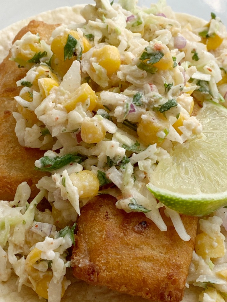 Easy Fish Tacos | Fish Taco Recipe | Easy Fish Tacos made with convenient frozen crispy fish sticks and a simple, 5 ingredient homemade cabbage slaw. Serve with corn tortillas for a simpler, and easier way to enjoy fish tacos. #fishtacos #easyrecipes #dinner #dinnerrecipes #tacos #tacorecipe