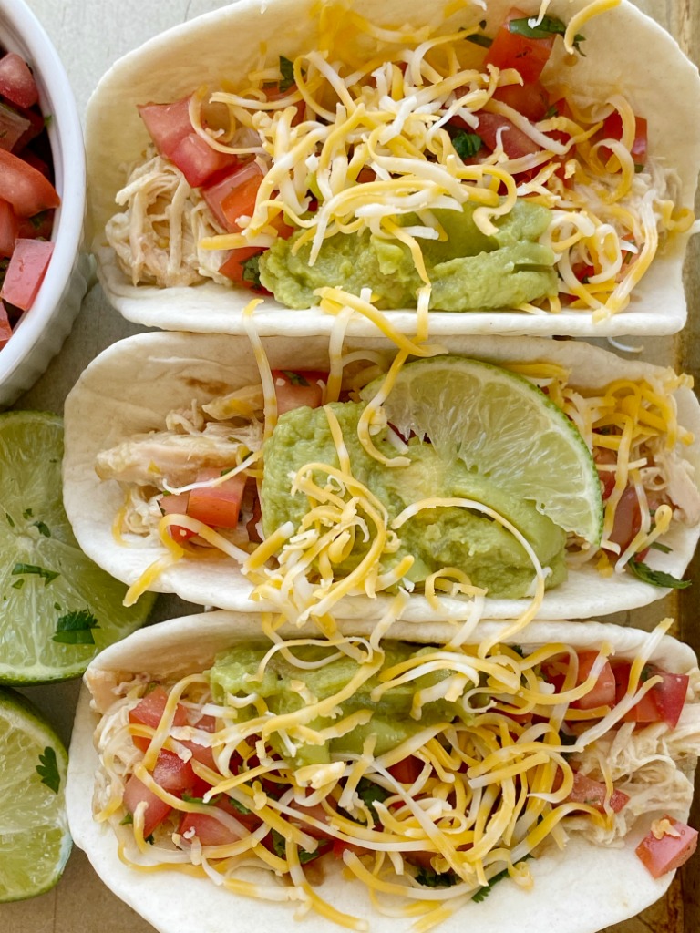 Honey Lime Salsa Verde Chicken Tacos cook in the slow cooker with only 6 ingredients! Fresh lime, salsa verde, honey, sour cream, and ranch seasoning make the best chicken tacos ever.