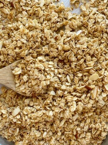 Homemade Coconut Oil Almond Granola uses simple ingredients like whole grain oats and almonds covered in a honey & coconut oil glaze.