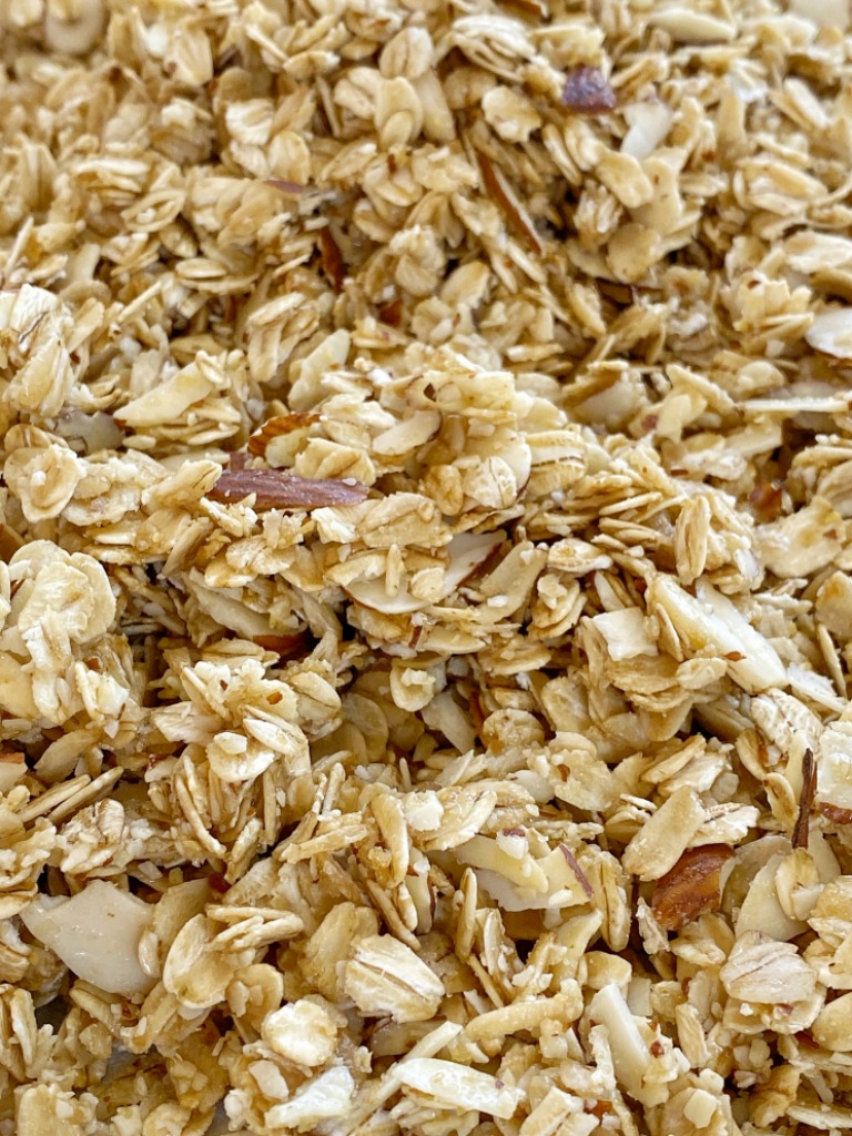 Homemade Coconut Oil Almond Granola uses simple ingredients like whole grain oats and almonds covered in a honey & coconut oil glaze.