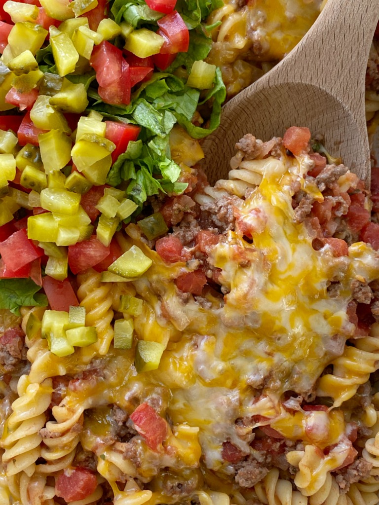 Cheeseburger Casserole is full of cheeseburger favorites like ground beef, onion, garlic, diced tomatoes, spiral pasta, mustard, seasonings, and lots of cheese. Different from traditional creamy, canned soup casseroles and it's family friendly!