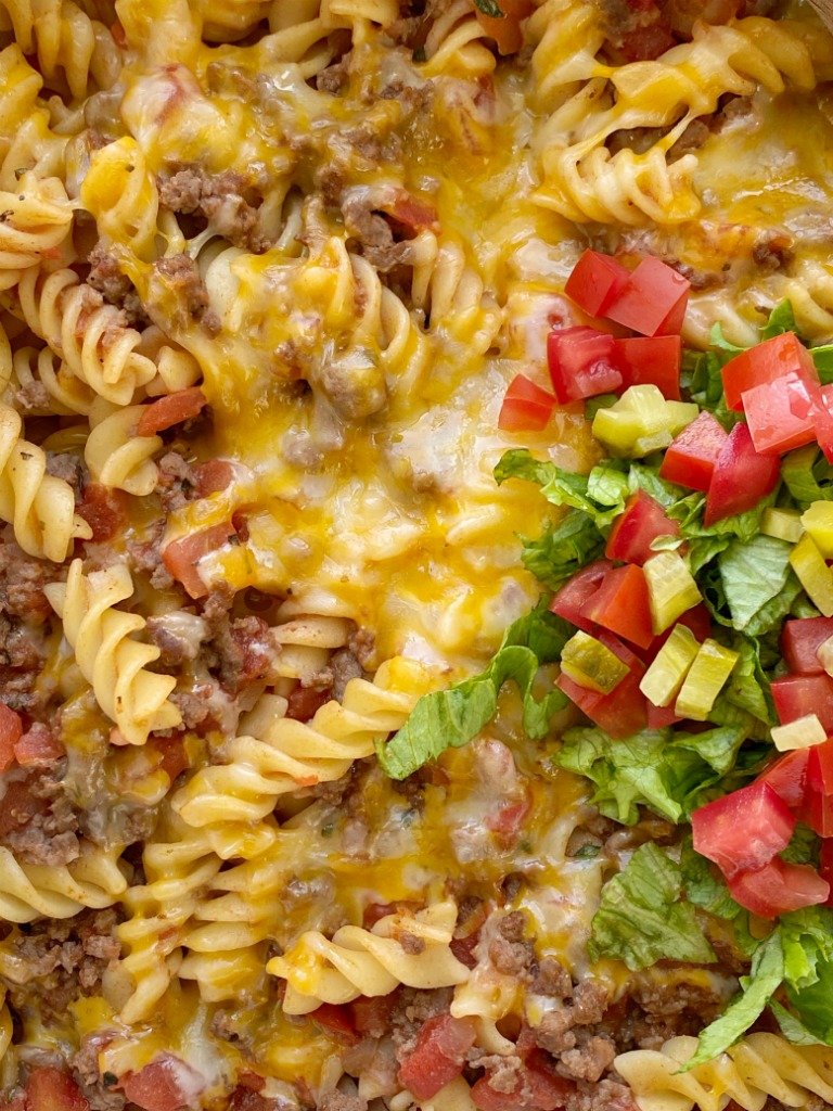 Cheeseburger Casserole is full of cheeseburger favorites like ground beef, onion, garlic, diced tomatoes, spiral pasta, mustard, seasonings, and lots of cheese. Different from traditional creamy, canned soup casseroles and it's family friendly!