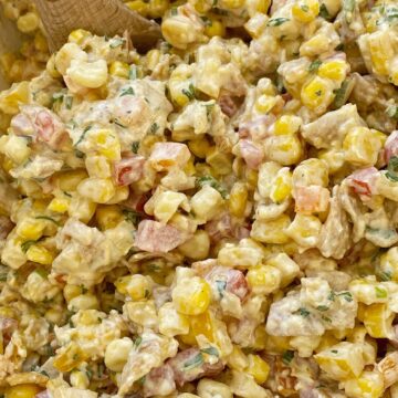 Fritos corn salad with corn, tomatoes, bell peppers, green onion, cilantro, and Fritos in a spiced creamy dressing. This is a salad no one will forget.