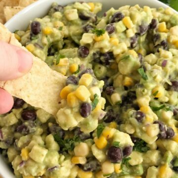 Avocado Dip | Appetizer | Dip | Dips with Avocados | Super Bowl Food | Party Food | Avocado dip is packed full with chunky avocados, corn, black beans, red onion and then drizzled with easy & convenient canned salsa verde. So much flavor with very little effort. Avocado dip is the best game day appetizer, chip dip, and party food | Together as Family #appetizerrecipes #appetizer #gamedaydips #gamedayappetizers #avocadodip #avocadodiprecipe #avocados