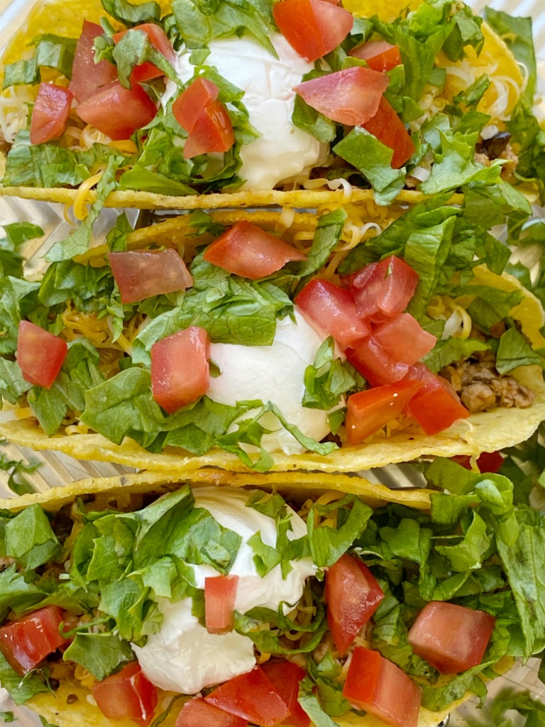 Green Chili Turkey Tacos with ground turkey, chopped onion, green chilies, black olives, and taco seasoning! A flavor explosion twist to traditional tacos. Top with lots of cheese and all your favorite taco toppings.