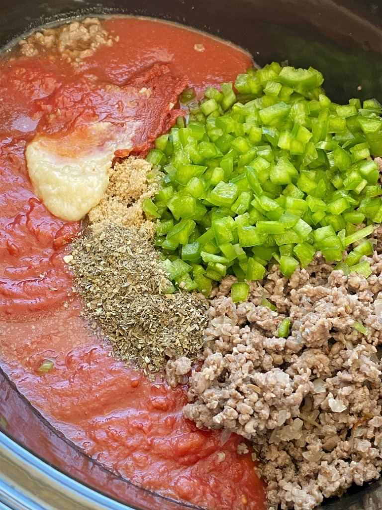 Come home to an Italian feast with this Slow Cooker ITALIAN SAUSAGE & BEEF SPAGHETTI SAUCE. Two meats simmer all day long in the crock pot for maximum flavor. Leftovers freeze really well for another pasta dinner night.