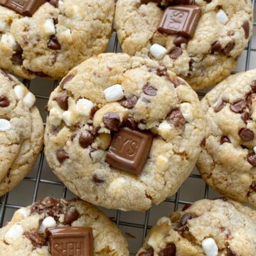 S'mores Dessert Recipes | Cookie Recipes | Smores Cookies are soft-baked, thick, and chewy. Graham cracker cookie dough base, marshmallow bits, Hershey's chocolate, and chocolate chips.