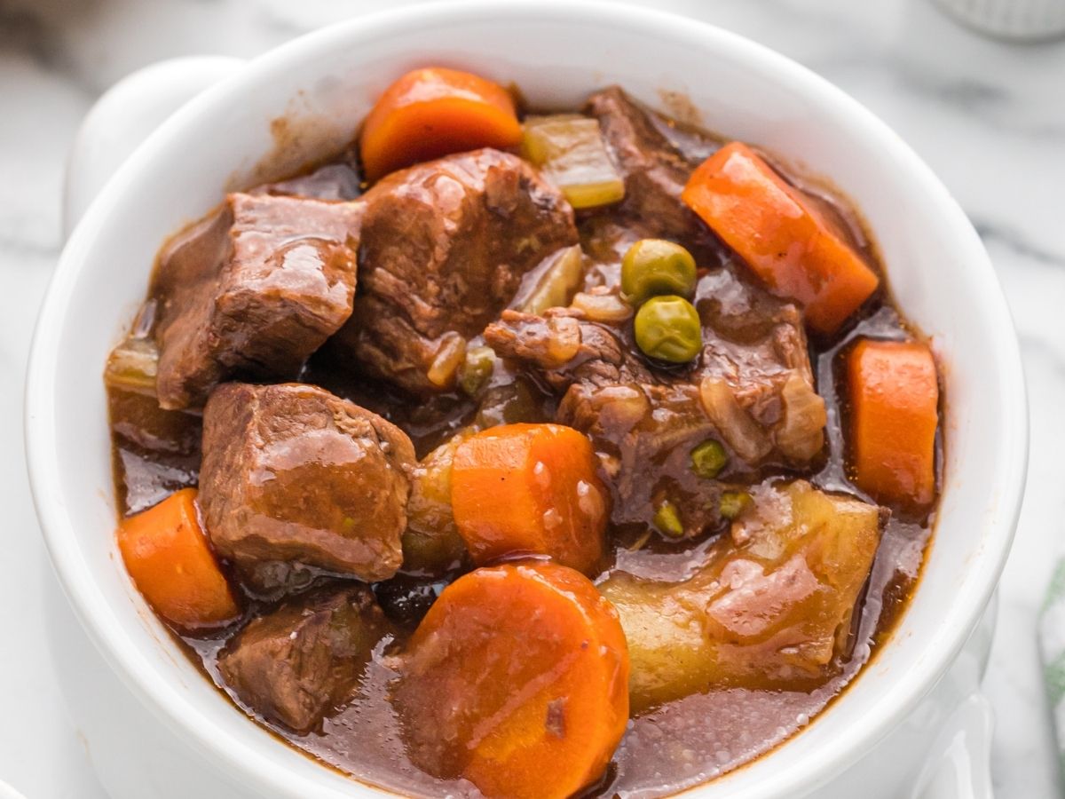 Picture of beef stew inside a white bowl. 