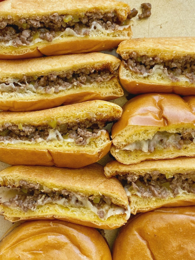 Philly Cheesesteak Sloppy Joes are a 30 minute dinner recipe. Ground beef simmers in one pan with onion, green pepper, beef broth, A-1 sauce, and steak seasoning. Serve on toasted buns with sliced provolone cheese.