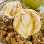Apple Cider Pudding Cake is a soft & fluffy apple spiced cake that creates it's own apple cider caramel syrup as it bakes! Topped with a brown sugar streusel for crunch and then served with vanilla ice cream.