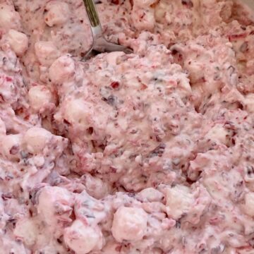 Cranberry Fluff is full of Fresh cranberries, crushed pineapple, heavy cream, and cream cheese. Cranberry fluff is so light, fluffy, sweet, tart, and the perfect mix of textures for a side dish at Thanksgiving dinner.