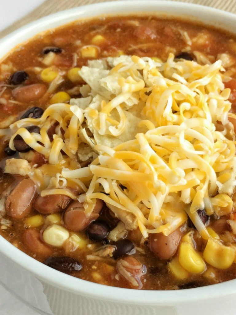 Dinner does not get any easier than this 7 can chicken taco soup! Dump 7 cans into a pot plus some seasonings and that's it! Serve with tortilla chips, cheese, and sour cream. You won't believe how yummy & easy it is.