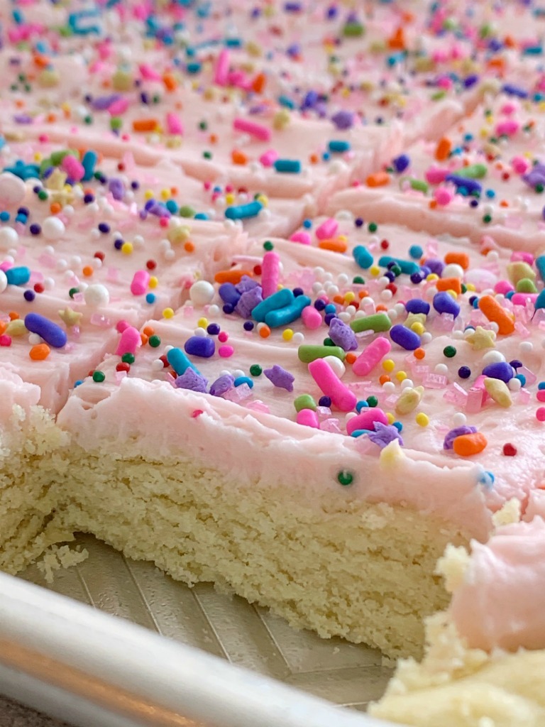 Sugar Cookie Bars | Sugar Cookie Bars are thick, soft-baked and topped with the best cream cheese frosting! Sugar cookie bars bake in a cookie sheet so there is plenty serve a crowd. Change up the frosting color and sprinkles for any event or Holiday.