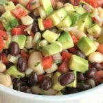 No party is complete without this addictive, super simple, and delicious game day dip! Full of beans, corn, avocado, red onion, tomatoes, and a surprise ingredient... Italian salad dressing.