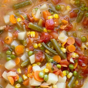 Vegetable Soup is packed with healthy and nutritious ingredients. Fresh vegetables in a perfectly seasoned broth base, and it cooks in one pot on the stove! Keeps for a week so leftovers are perfect for a healthy lunch.