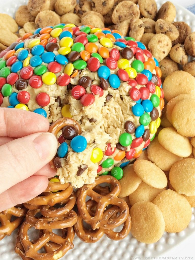 Monster cookie dough cheeseball dip has no eggs and no flour! Everything you love about monster cookies; oats, peanut butter, chocolate chips, and m&m's but in a fun and tasty cheeseball. Serve with pretzels, graham crackers, and cookies.