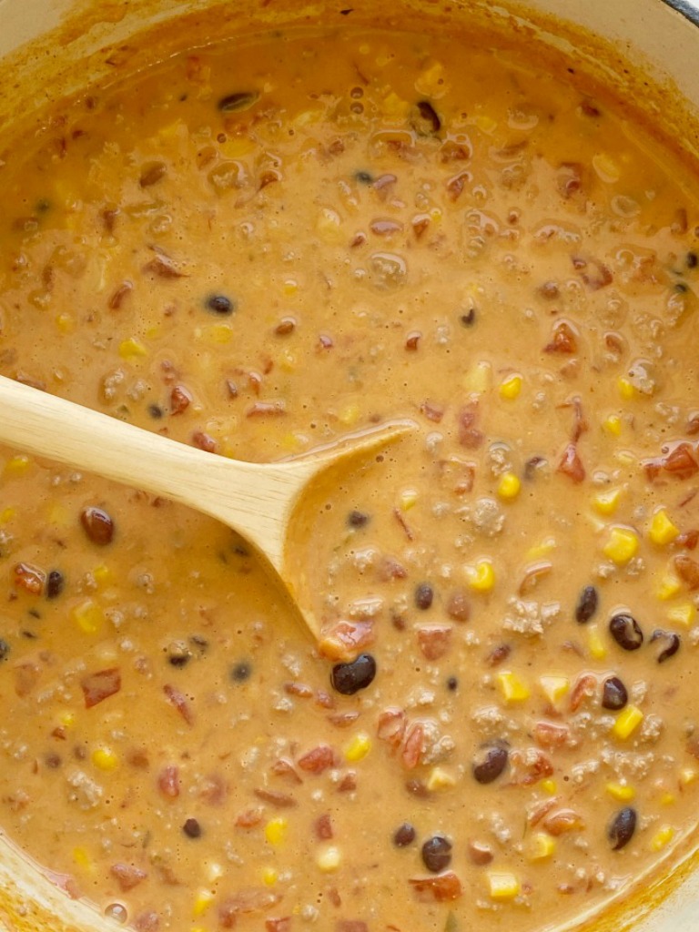 Cheesy Taco Soup is so easy to make in just one pot! Ground turkey, chili beans, black beans, tomatoes, corn, and salsa simmer in chicken broth. Add some Velveeta cheese for the smoothest cheesy taco soup ever. The perfect one pot, 30 minute easy dinner recipe.