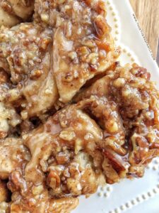 Overnight caramel pecan cinnamon rolls are so easy to make! Uses frozen bread dough and you prepare it the night before.