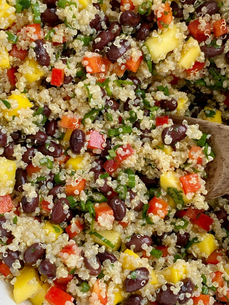 Mango black bean quinoa salad is a light & healthy salad. Protein packed quinoa, black beans, sweet mango, crisp red peppers, green onions, and cilantro covered in an easy olive oil vinaigrette dressing. It's also great for lunch prep!
