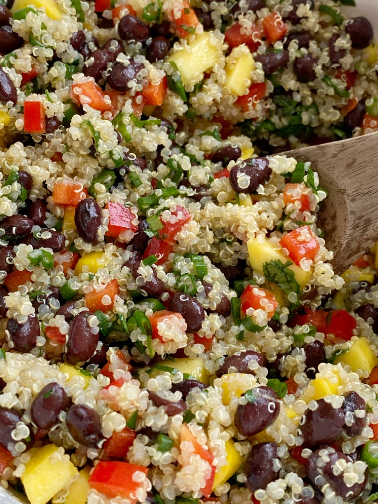 Mango black bean quinoa salad is a light & healthy salad. Protein packed quinoa, black beans, sweet mango, crisp red peppers, green onions, and cilantro covered in an easy olive oil vinaigrette dressing. It's also great for lunch prep!