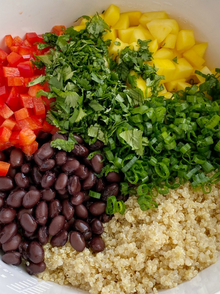 Mango black bean quinoa salad is a light & healthy salad. Protein packed quinoa, black beans, sweet mango, crisp red peppers, green onions, and cilantro covered in an easy olive oil vinaigrette dressing. It's also great for lunch prep!