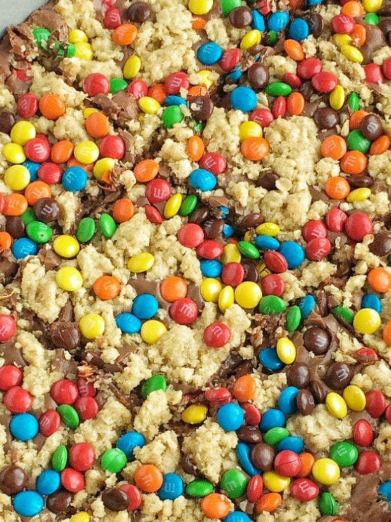 M&M Chocolate Fudge Oatmeal Bars have a buttery sweet oatmeal crust with a chocolate fudge middle, and topped with more oatmeal crumble and m&m candies. These bars a rich, chocolatey treat!