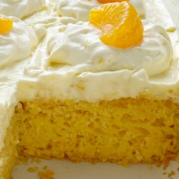 Pig Pickin' Cake Recipe | Cake Mix | Boxed Cake Mix | Easy Dessert Recipe | Orange Pineapple Cake is an easy cake recipe that starts with a boxed cake mix and canned mandarin oranges. Topped with a delicious and fluffy whipped pineapple vanilla pudding frosting. So moist, light, and refreshing.
