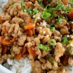 Teriyaki Chicken Rice Bowls | Teriyaki Chicken Recipe | Rice Bowls | Teriyaki chicken rice bowls take 30 minutes to make and are perfect for a busy weeknight dinner. Ground chicken, broccoli, and carrots simmer on the stove top in a delicious and simple teriyaki sauce. Serve over rice and garnish with green onions! #easydinner #dinnerrecipes #chickenrecipes #30minutemeals #teriyakichicken #ricebowls #recipeoftheday