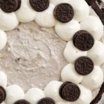 Oreo pudding pie garnished with whipped cream and Oreo cookies.